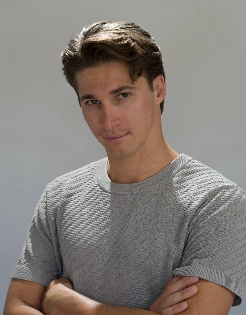 Men's flow cut with longer side-swept hair at Dino's Barbershop, San Diego