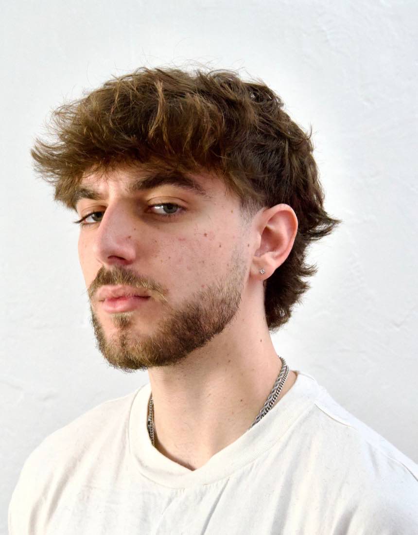 Men's longer curly hair grown out over the ears at Dino's Barbershop, Normal Heights San Diego
